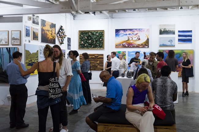 Locals attending exhibiton at aMBUSH Gallery