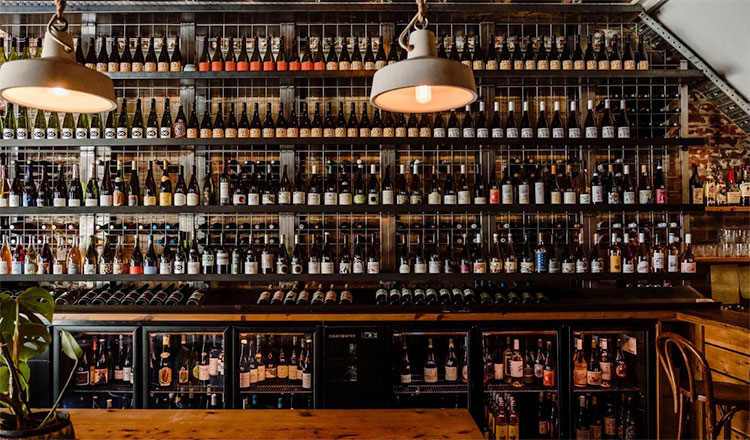 a shelving unit filled with wine bottles