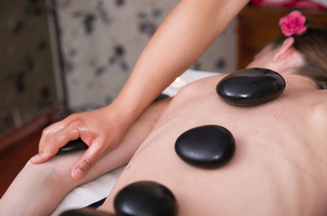 a woman getting a hot rocks massage