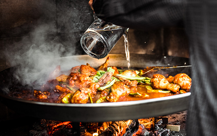 a large dish of paella cooking