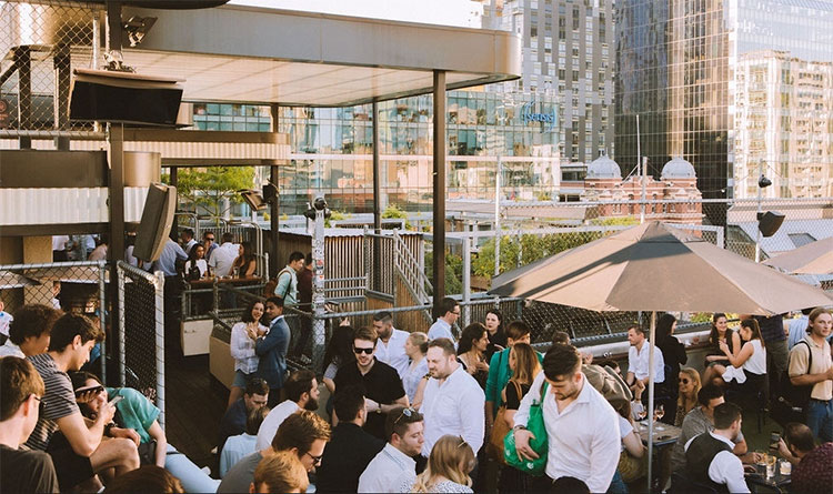 a rooftop bar in melbourne filled with people