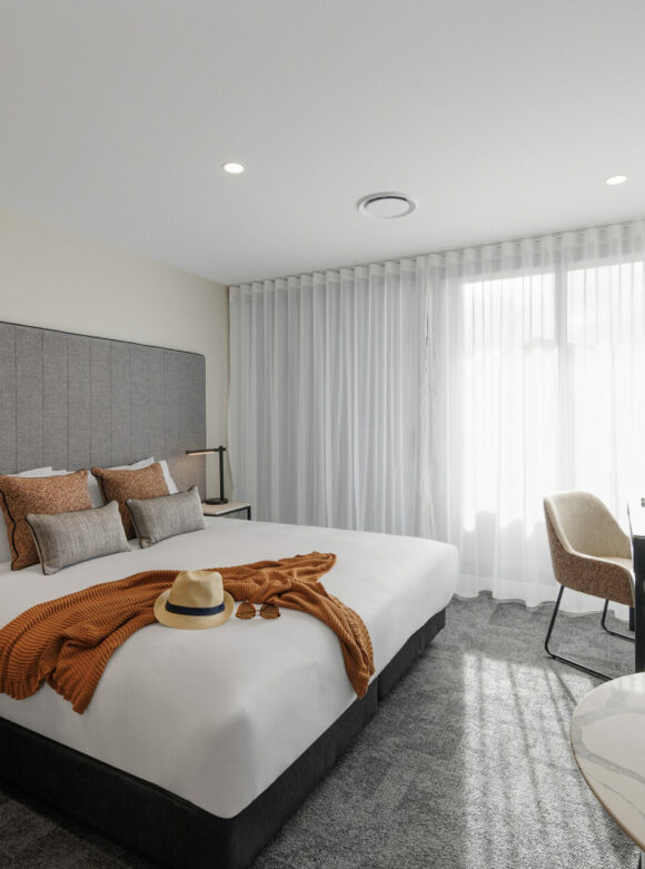 Bedroom 2 Bedhead, queen sized bed, bedside tables, lamps, interconnecting studio apartment hotel, TV, interconnecting 2-bedroom apartment hotel